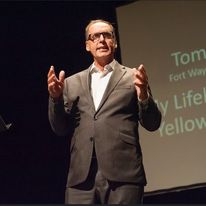 Tom Didier giving a presentation at a benefit for Arts United